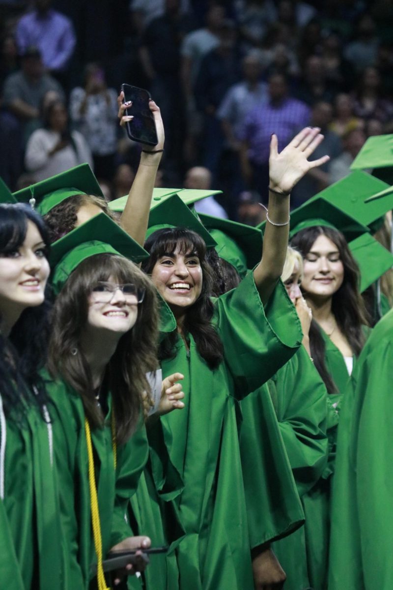 Graduates waving 