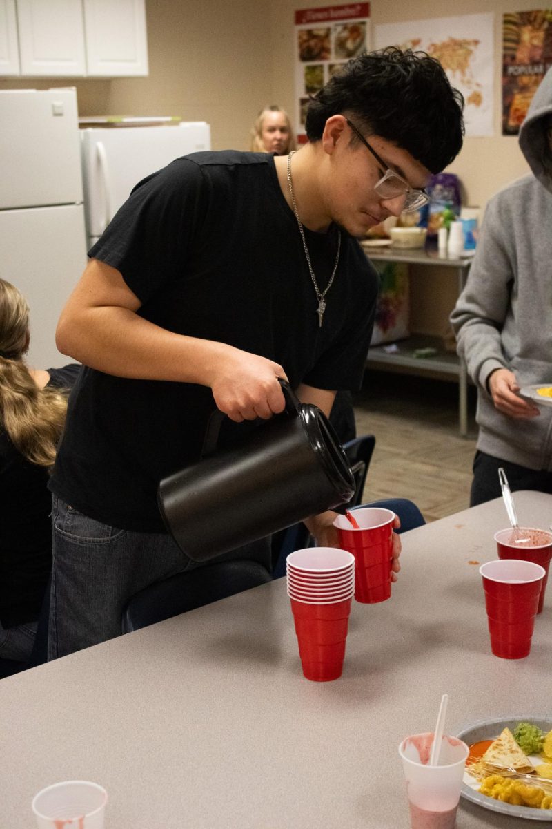 Student pours Koolaid. 