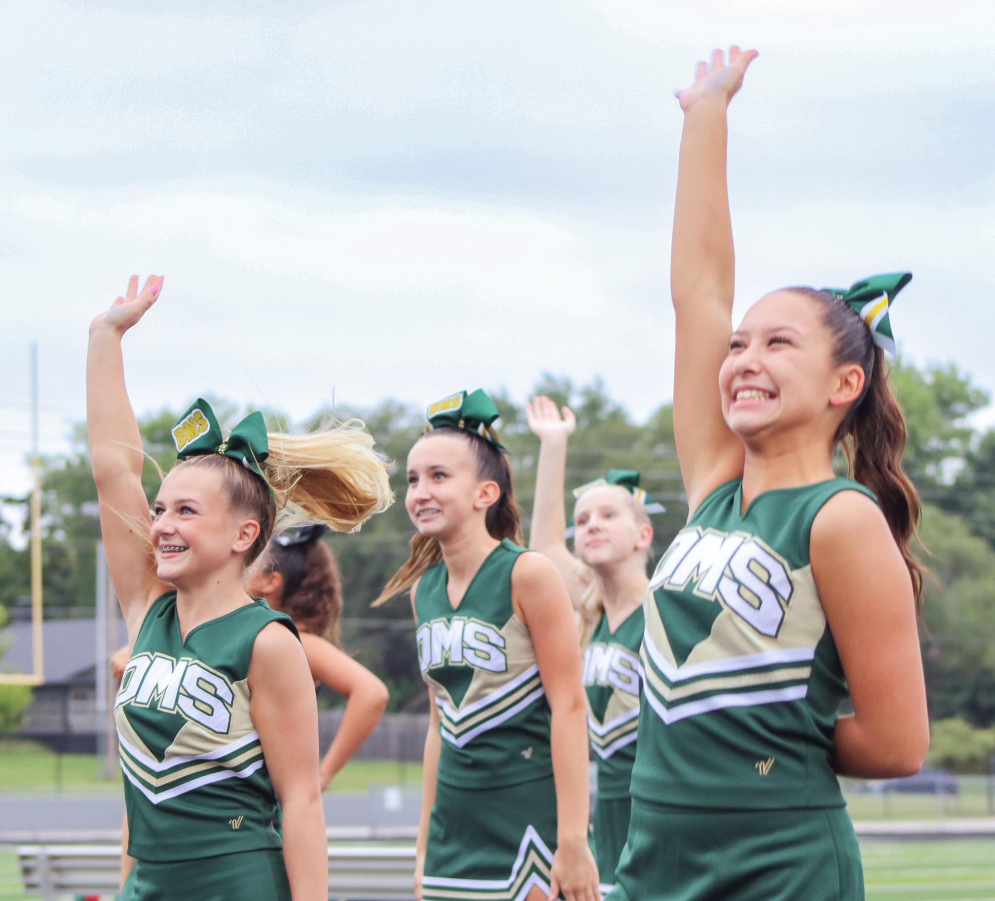 DMS cheerleaders wave. 