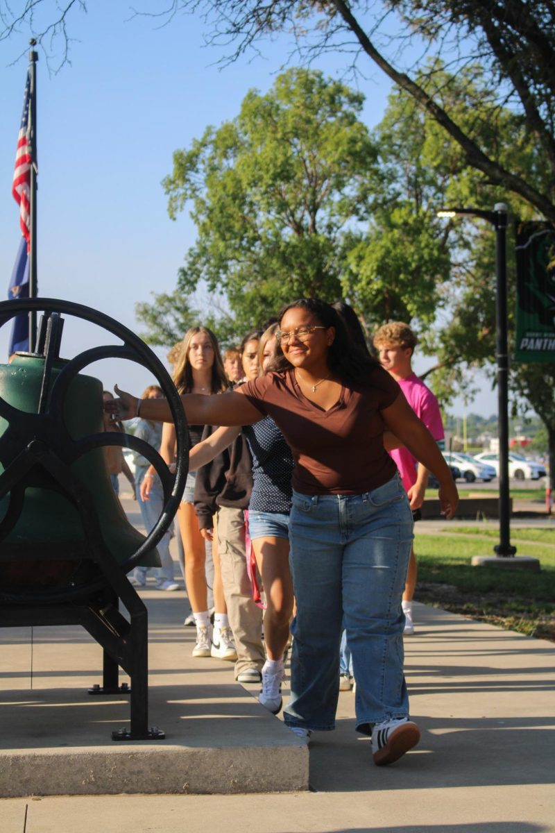 Student touches the bell. 