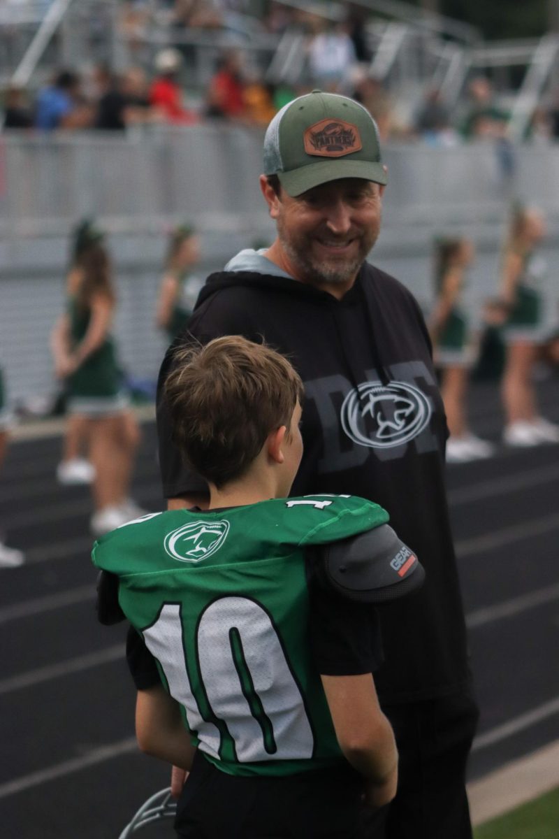 Derby junior football player talks to coach.