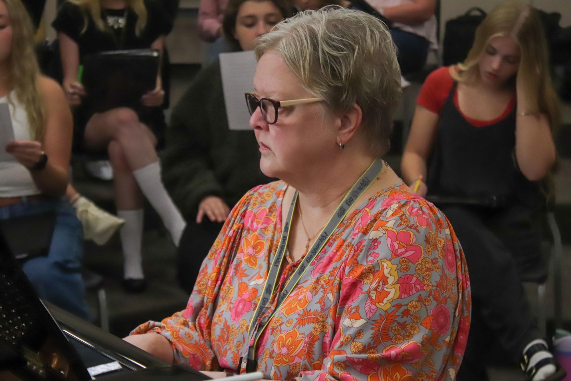 Accompanist, Mrs Snider plays piano for choir.