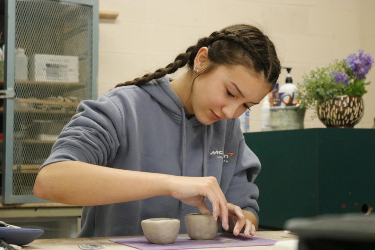Students work on combining two pieces of clay on Aug. 20.
