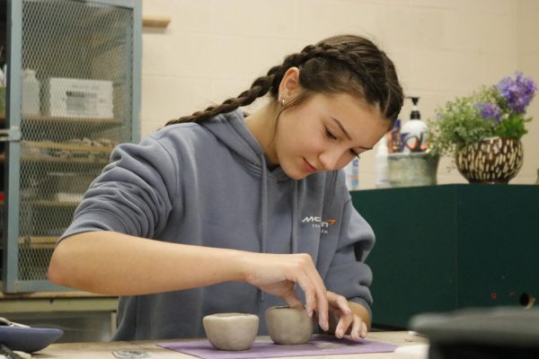 Students work on combining two pieces of clay on Aug. 20.