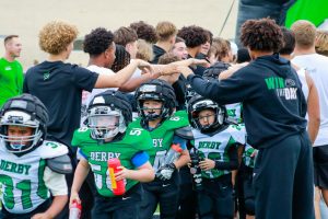 Junior Footballers run through tunnel of DHS Football players.