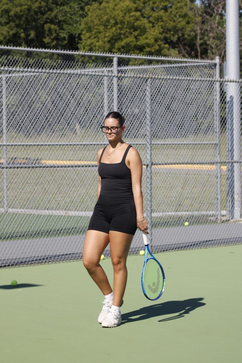 Tennis player walks off the court.