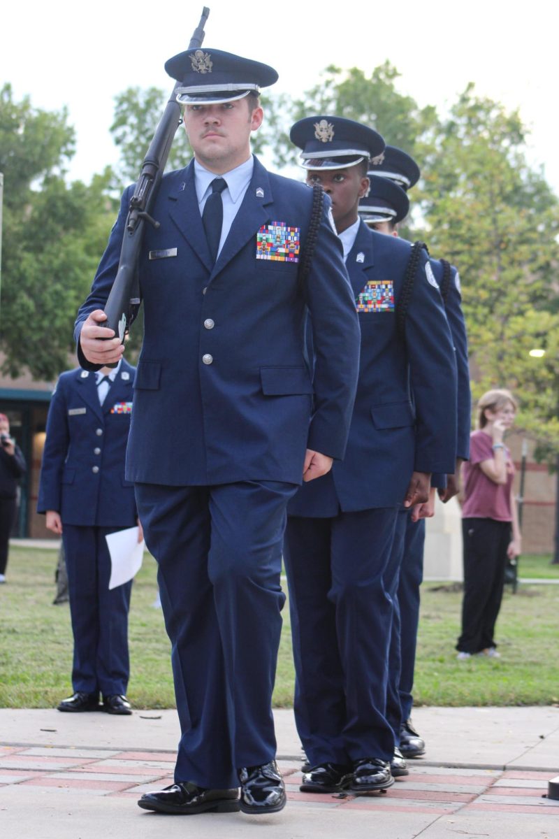 AFJROTC members walk in formation. 
