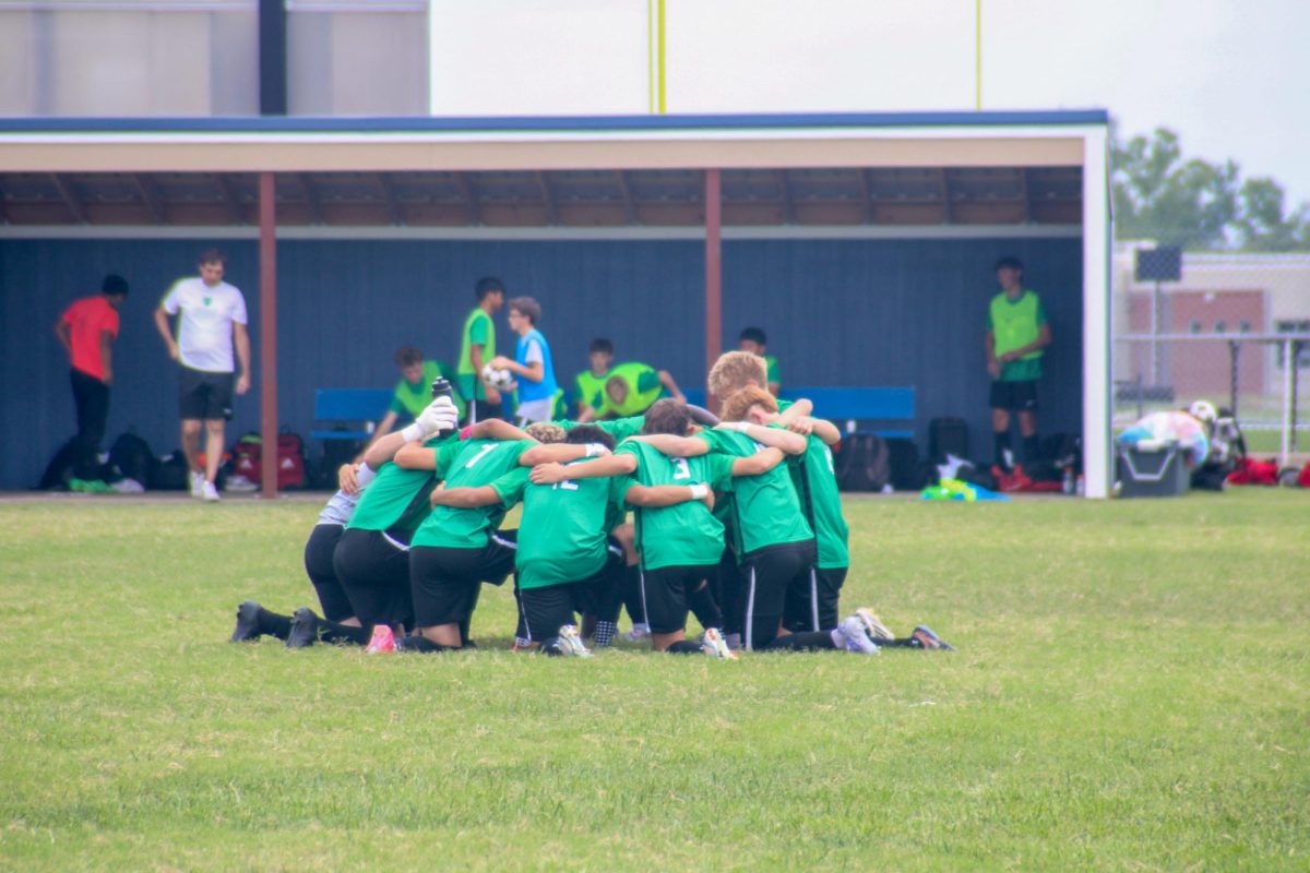 Starting players kneel before game.