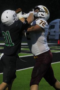 Players tackle on the field.