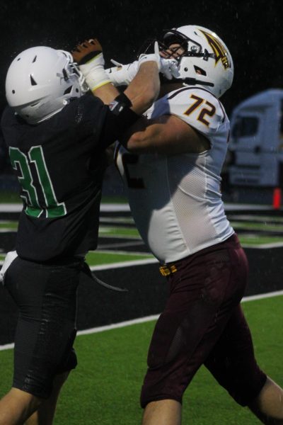 Players tackle on the field.