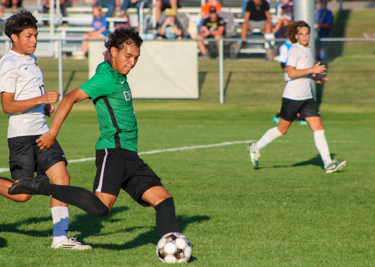 Soccer player kicks the ball.