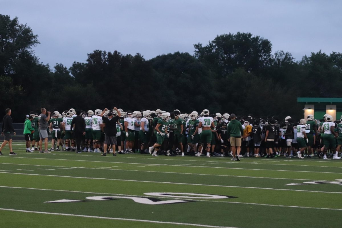 Football team scrimages at Derby Night Lights.
