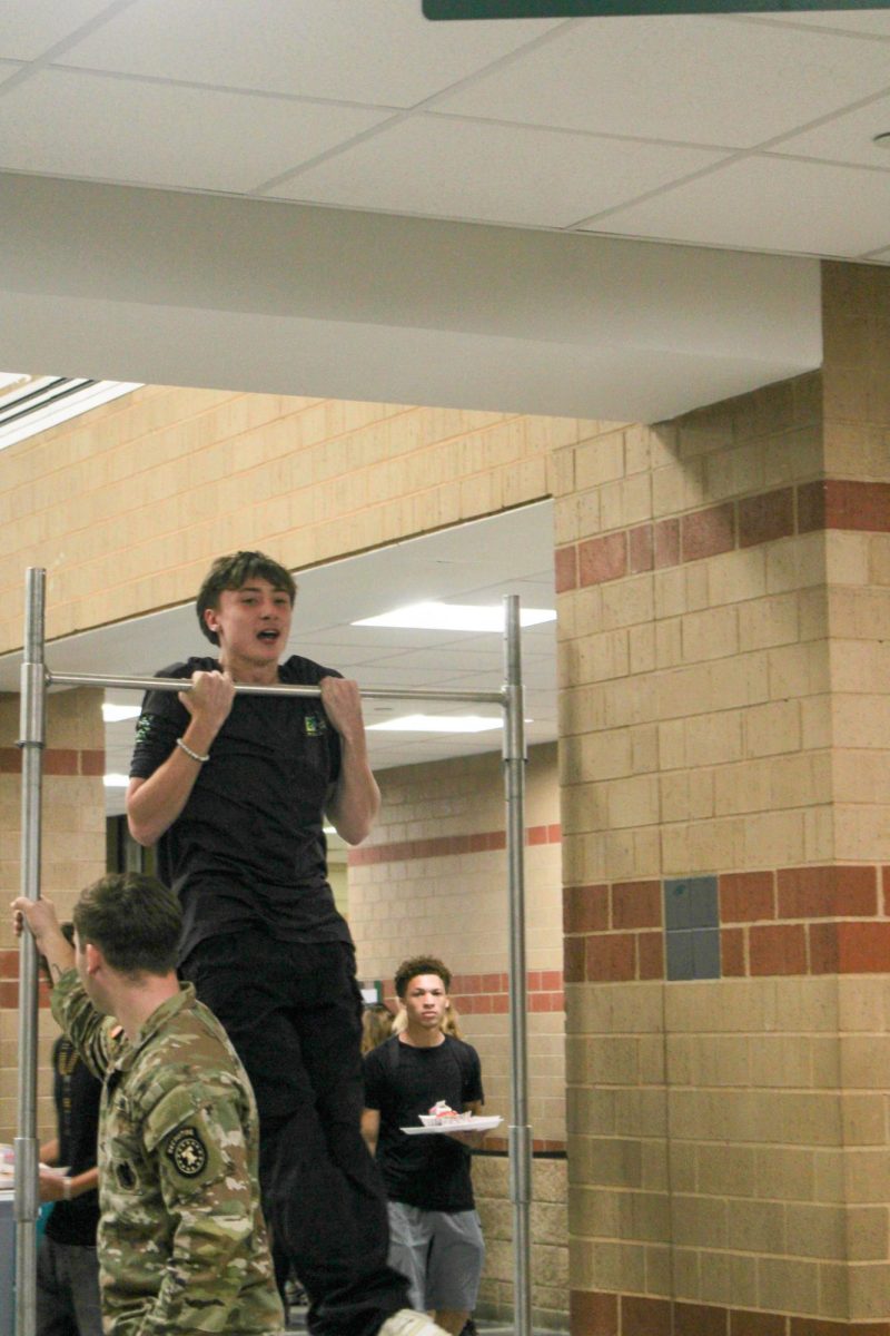 A student at lunch doing the push up challenge.