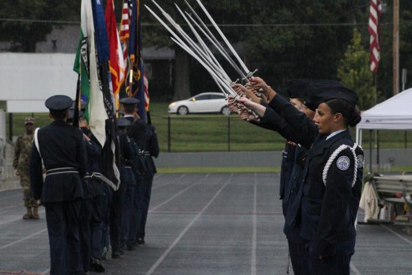 ROTC does a demonstration with special armed forces flags. 