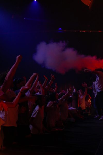 People sing and raise their hands in worship. 