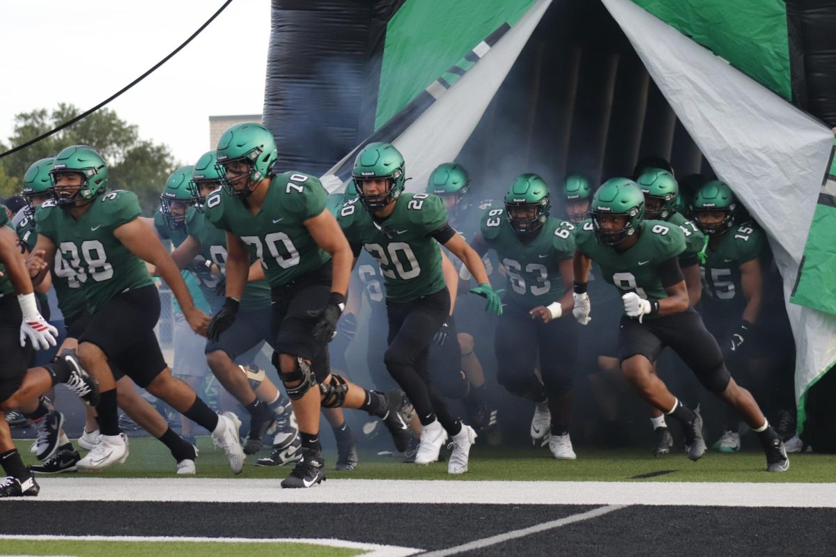 Derby Football players bursting through the tunnel to start the game. 