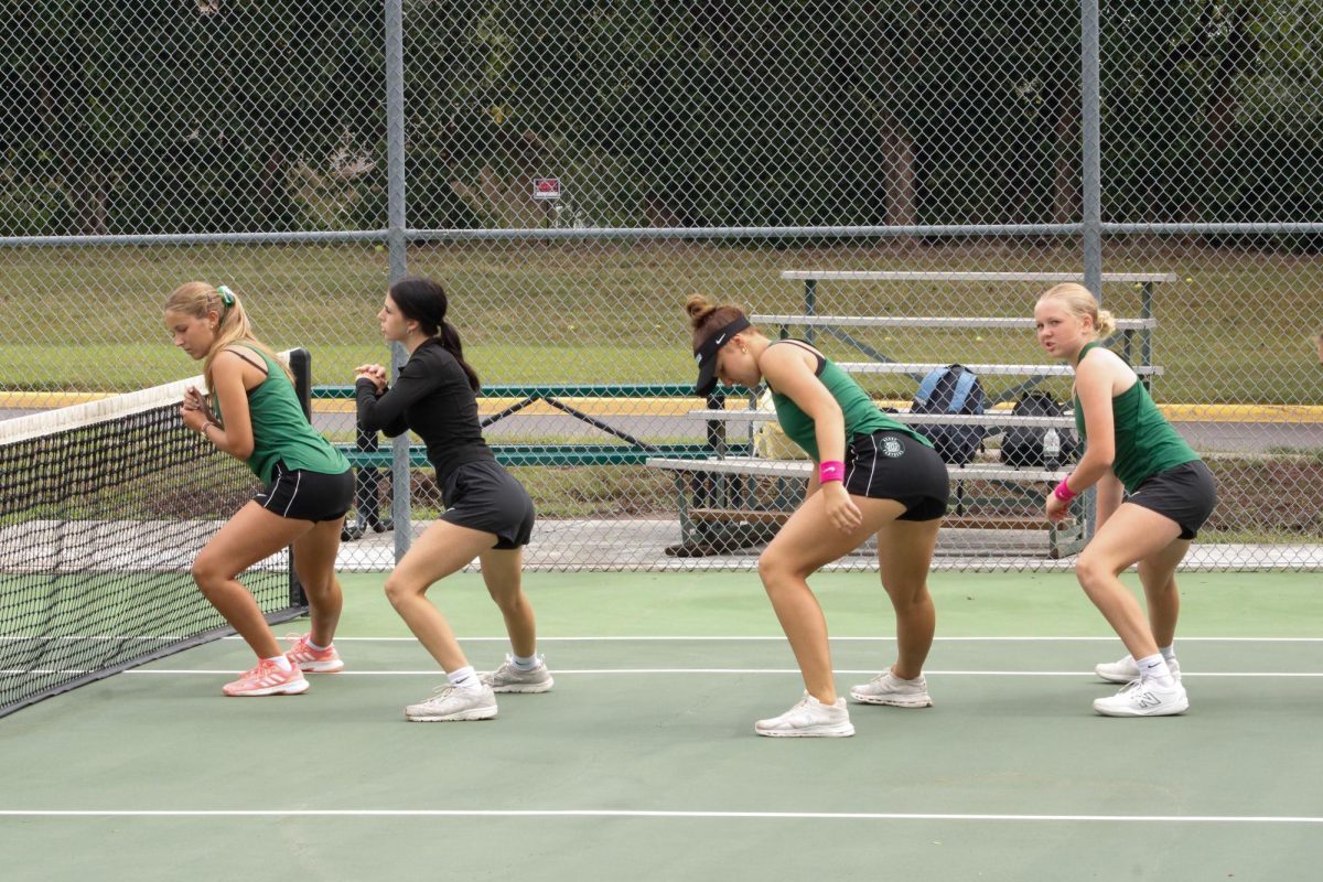Players do side lunges as their warm up.