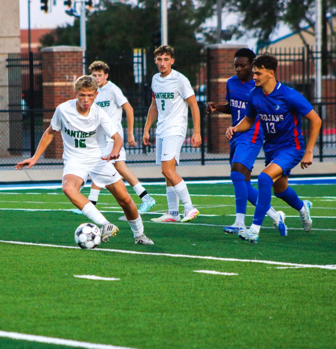 Player kicks the ball to teammate. 