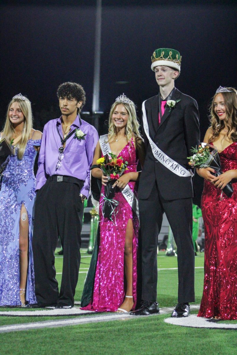 Senior Homecoming candidates Keeley Chance, Ashlyn Zerger, Cale Clingan, and Camryn Gonzalez, smile for a picture. 