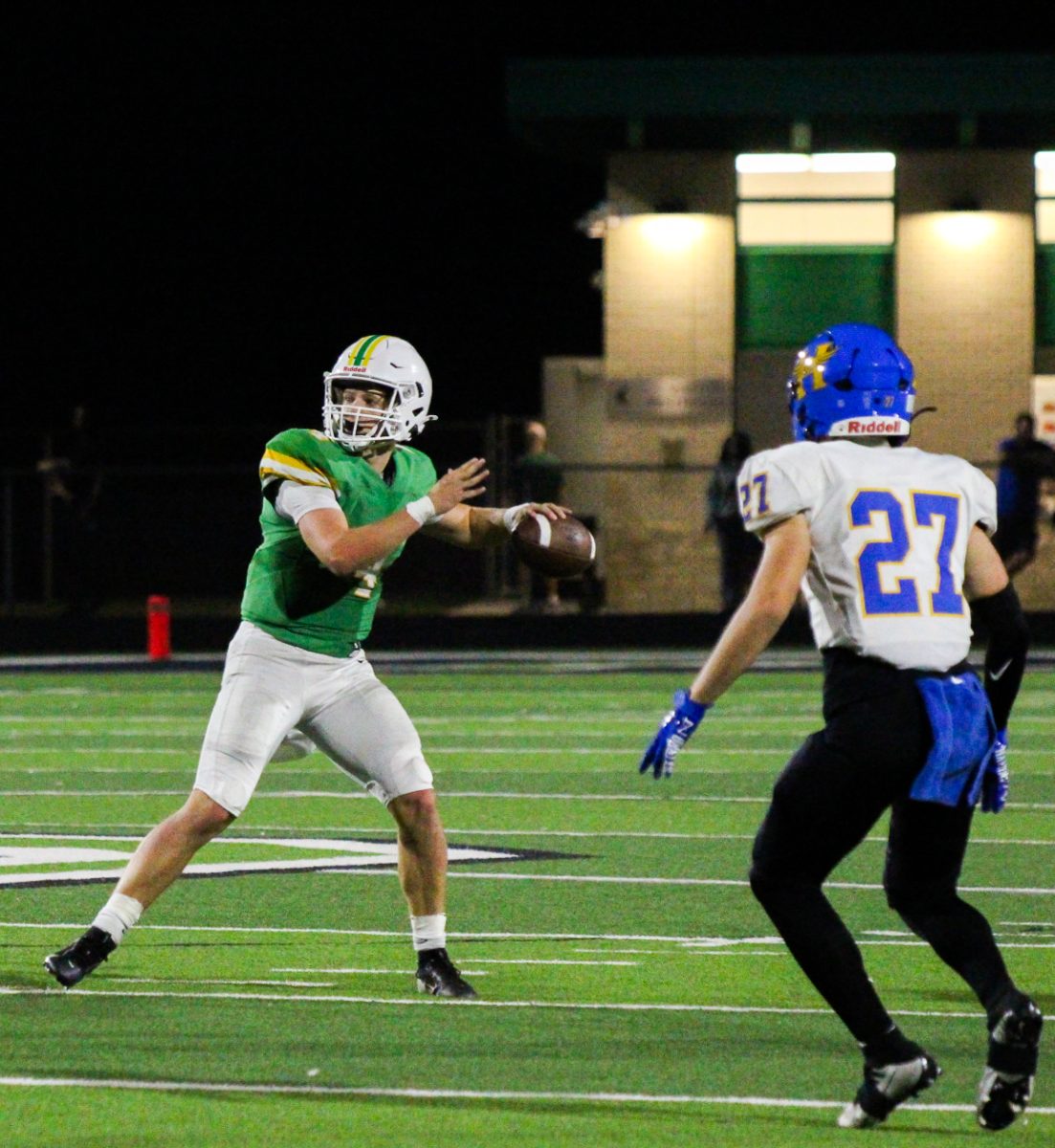 Derby player about to throw the ball as he is being pursued. 