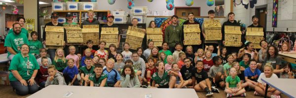 Panthers and Tanglewood Tigers come together to take a group photo with their Bat houses