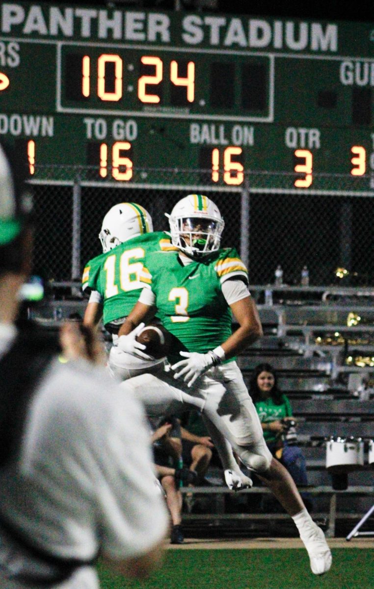 Players 16 and 3 celebrate a touchdown