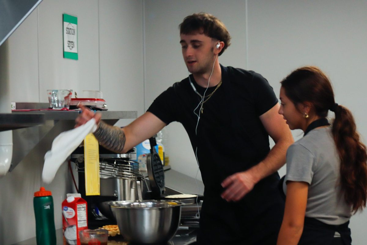 Culinary students cook waffles.