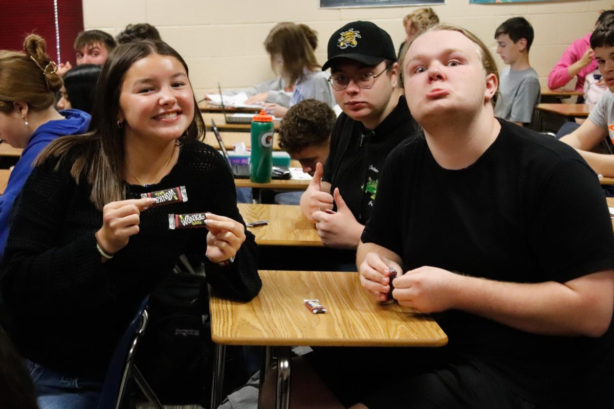 Olivia Grosser (left), Kaden Blackburn (left), and Gage Campbell (far left) pose for photo. 