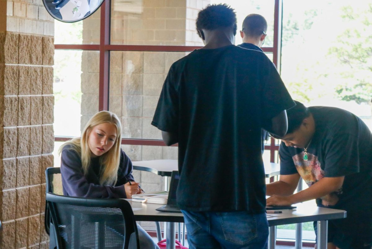 Students sign papers for the last day of free application day.