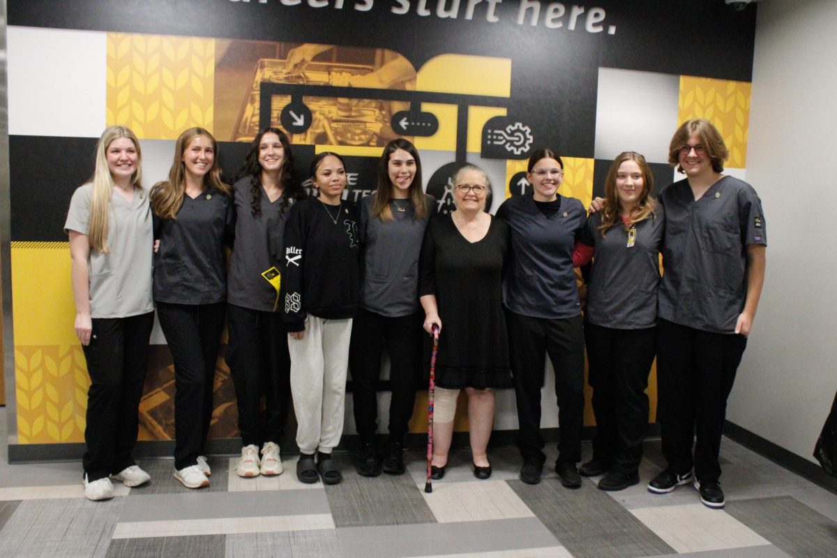 A group photo of all the CNA students and their instructor.