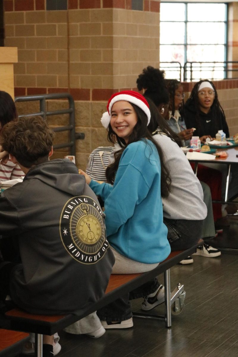 Sophomore Aliza Biddle smiles with a Santa hat.