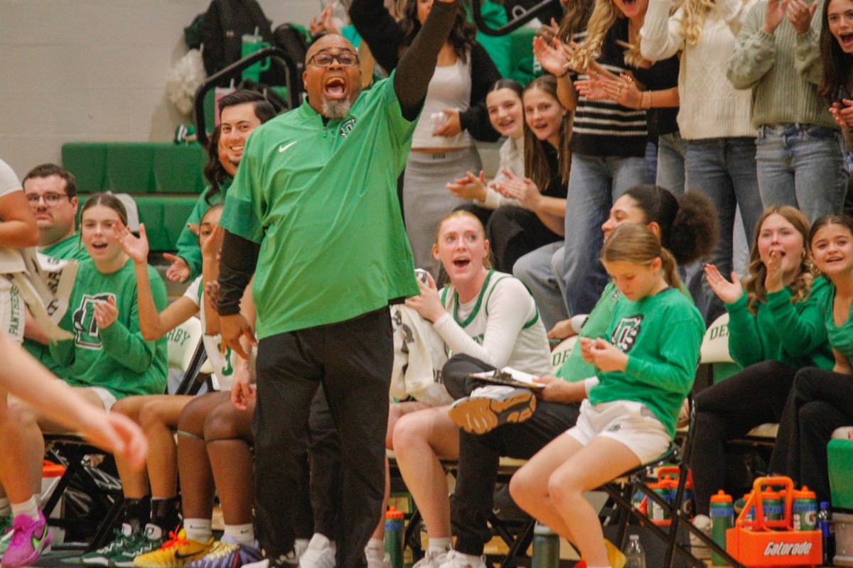 Coach Chadwick of Derby cheers on his players. 