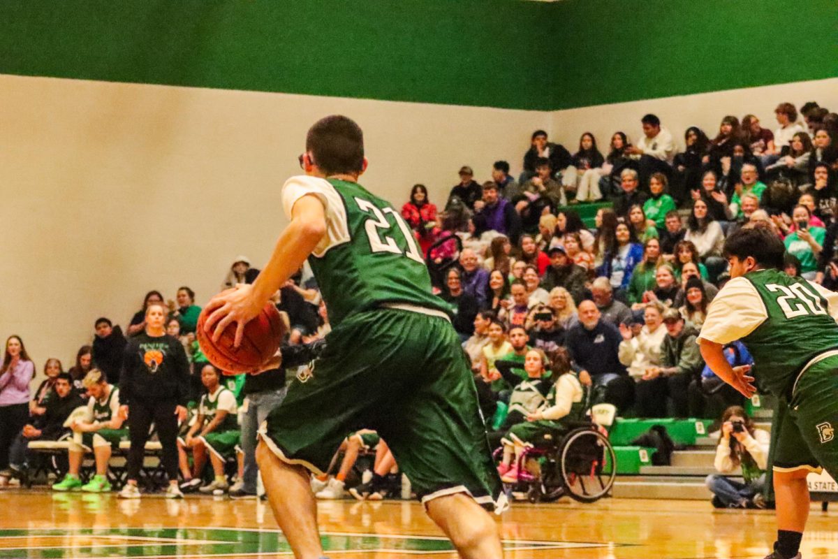 Student running with the basketball.