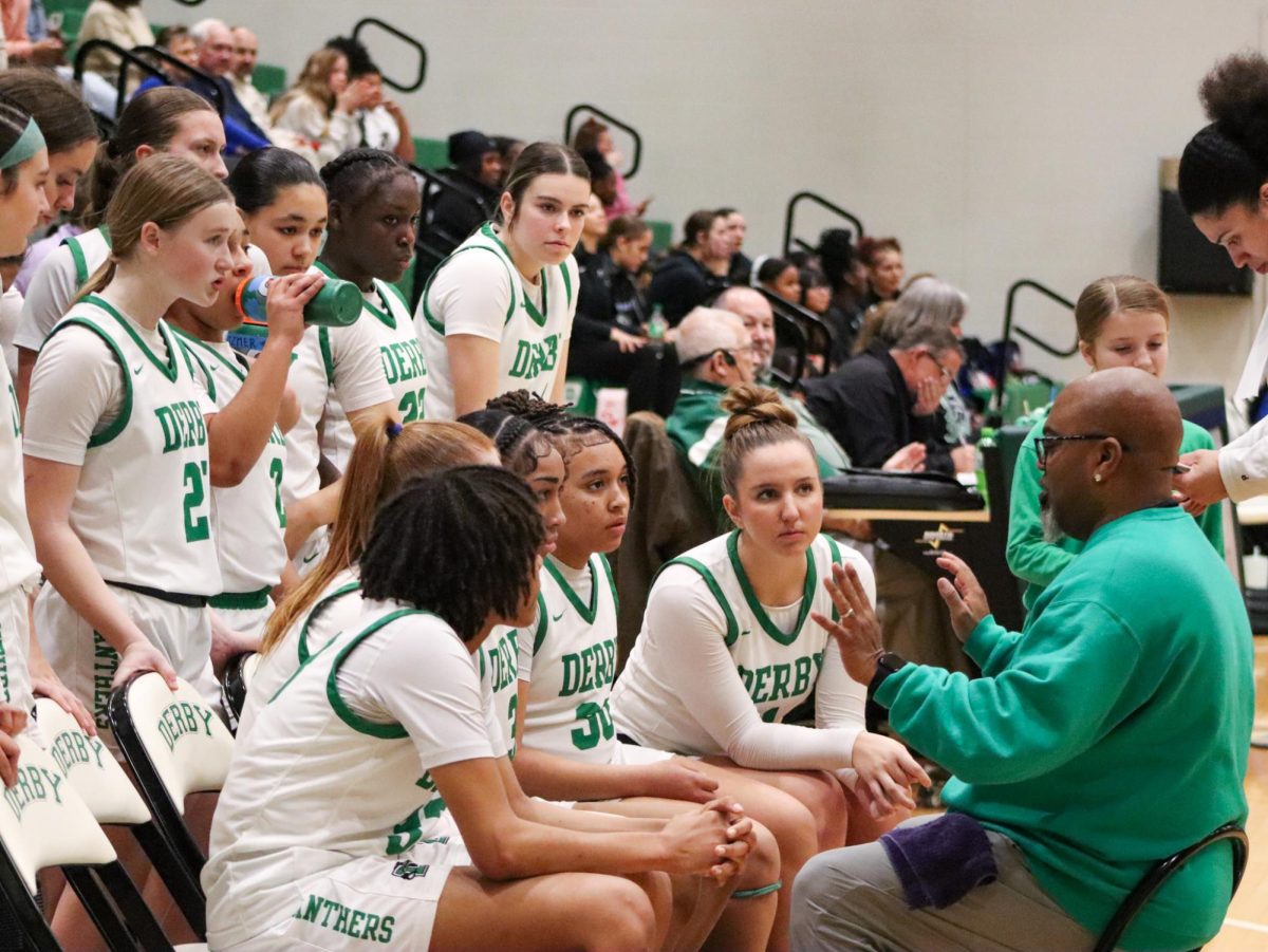 Players listen to Coach Bryan Chadwick during a timeout. 