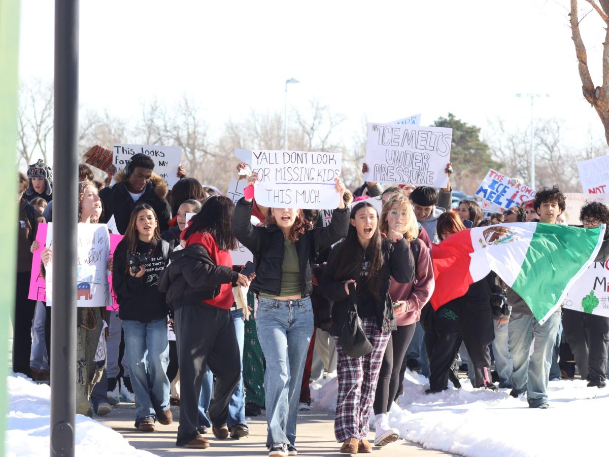 Students hold up signs during protest. 
