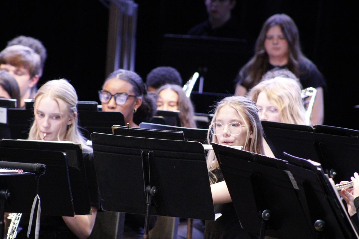 Students play flute for their piece.