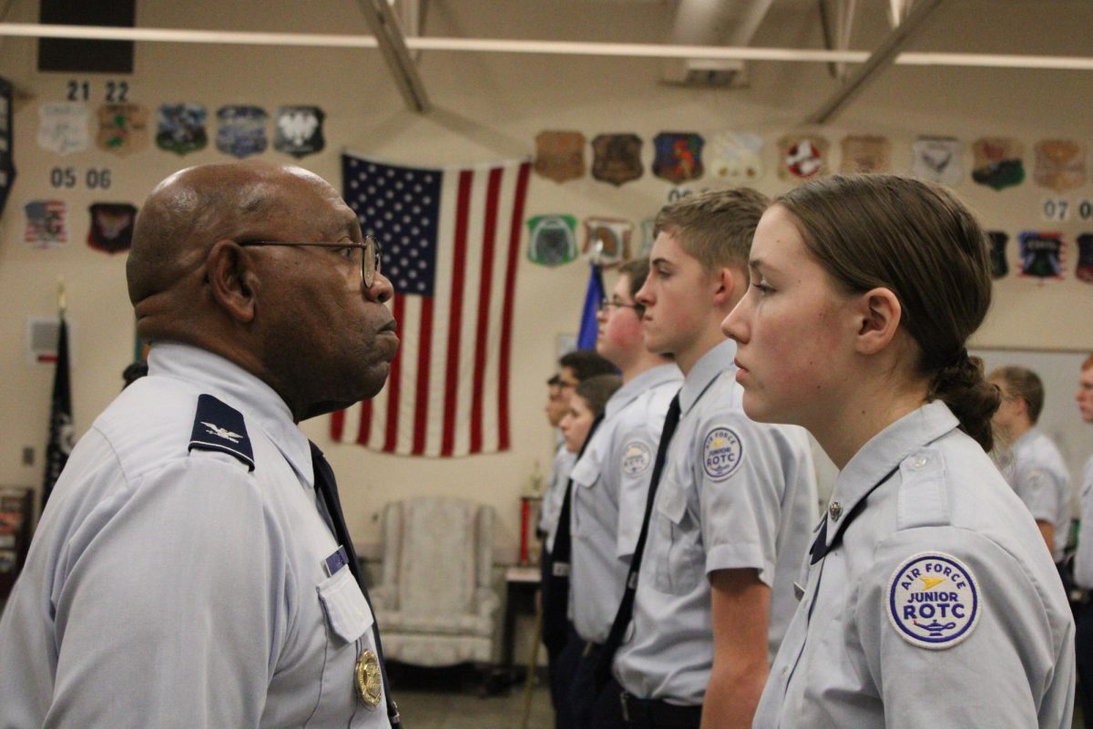 Colonel Michael Dillard locks eyes with student.