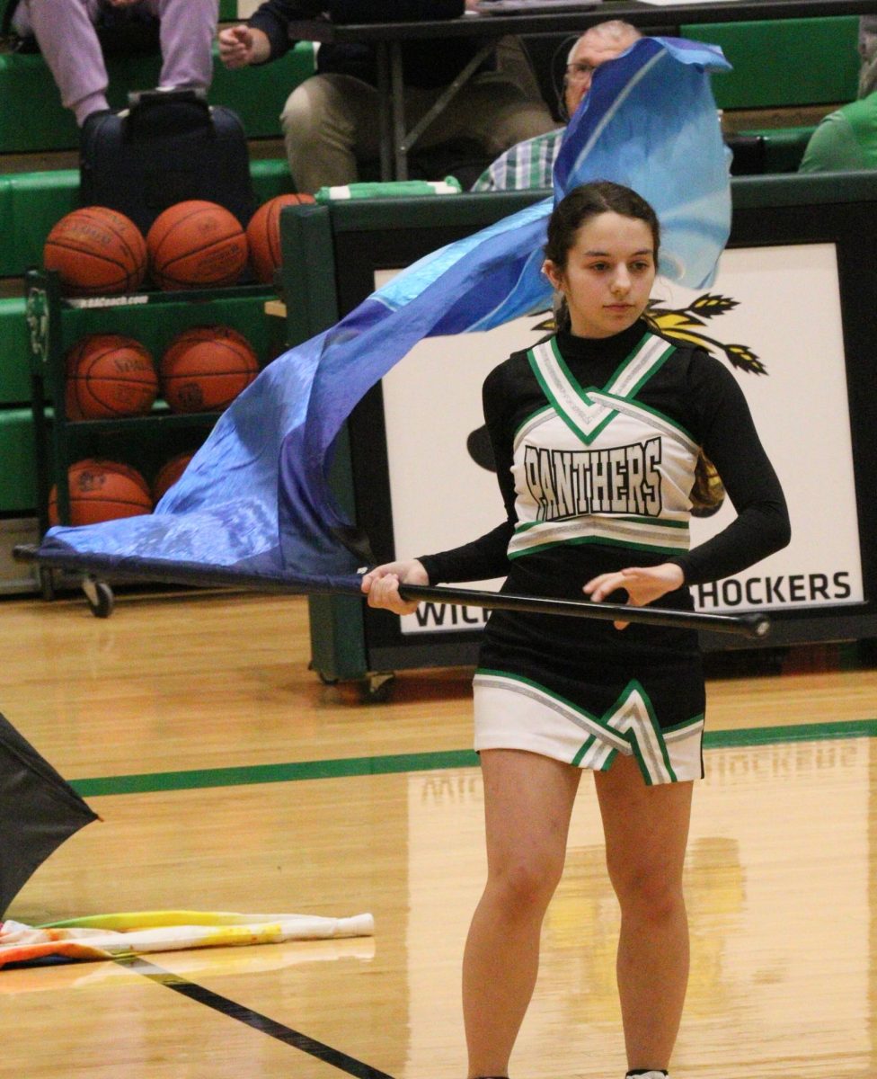 With a competition around the corner in Hutchinson, the Winter Guard performs their 2026 program titled 'Rainbow' during the girls game at halftime.