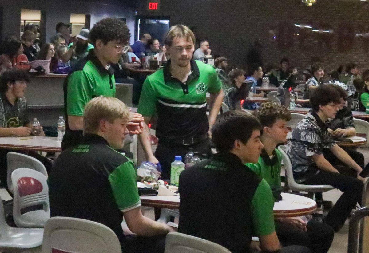 Boys bowling team discussing.
