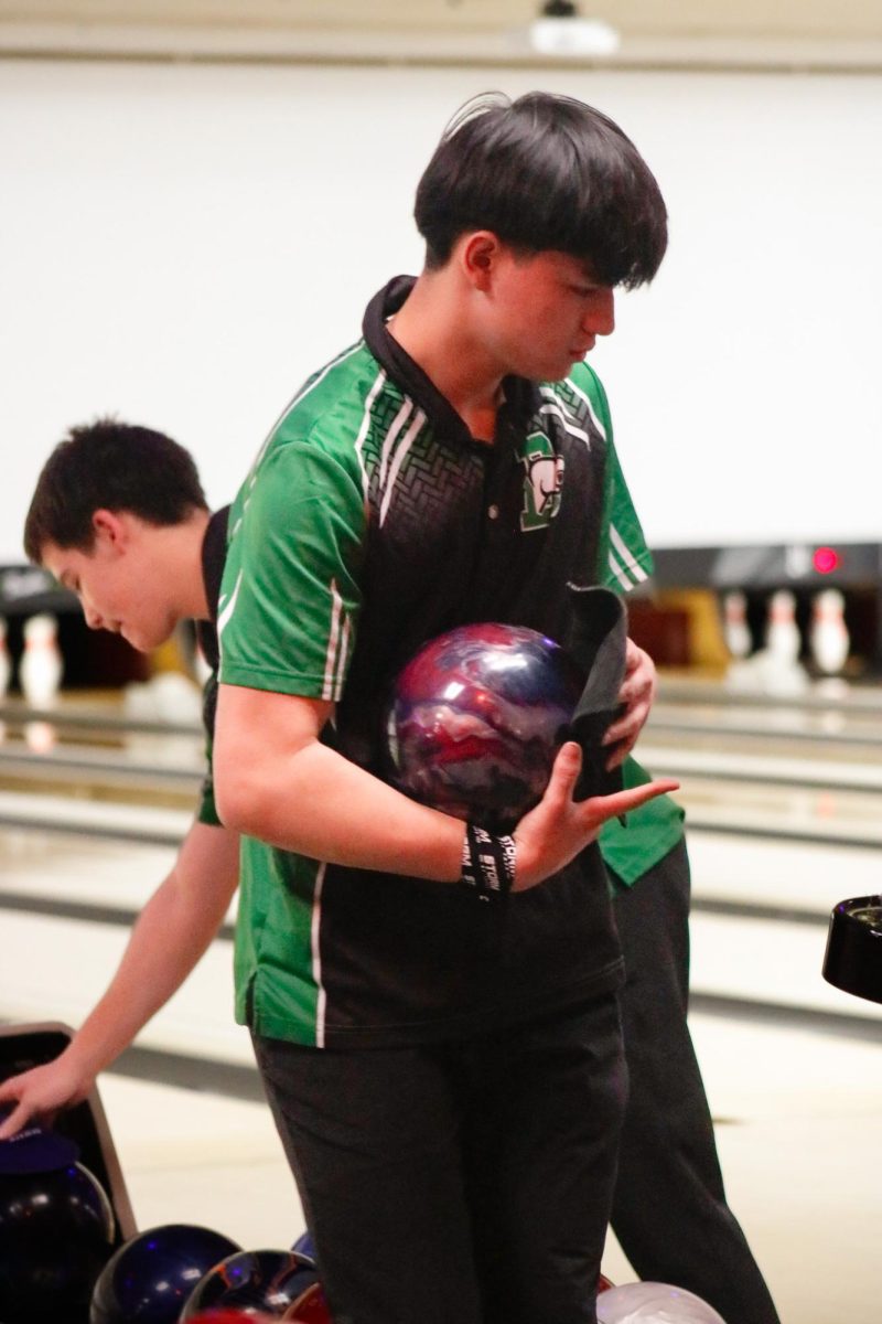 Junior Michael Stanger holds a bowling ball before he bowls. 