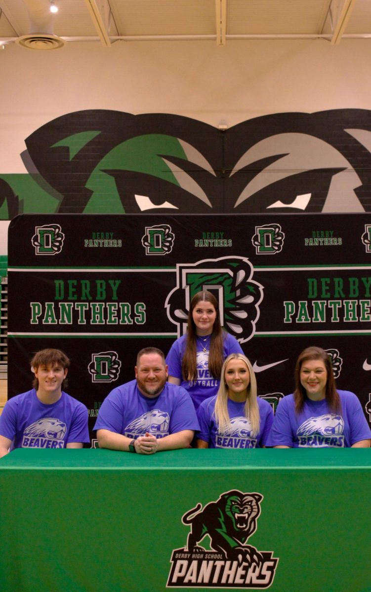 student signing with family 