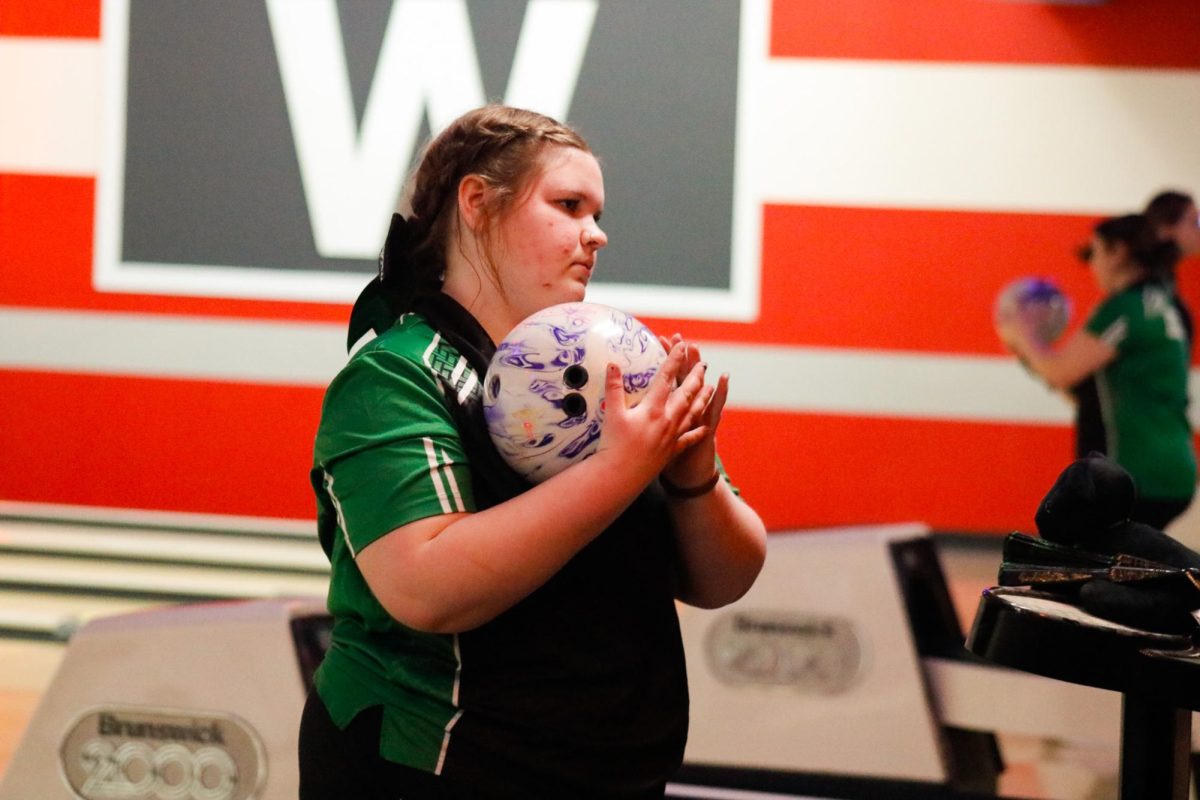 Student carrying bowling ball.