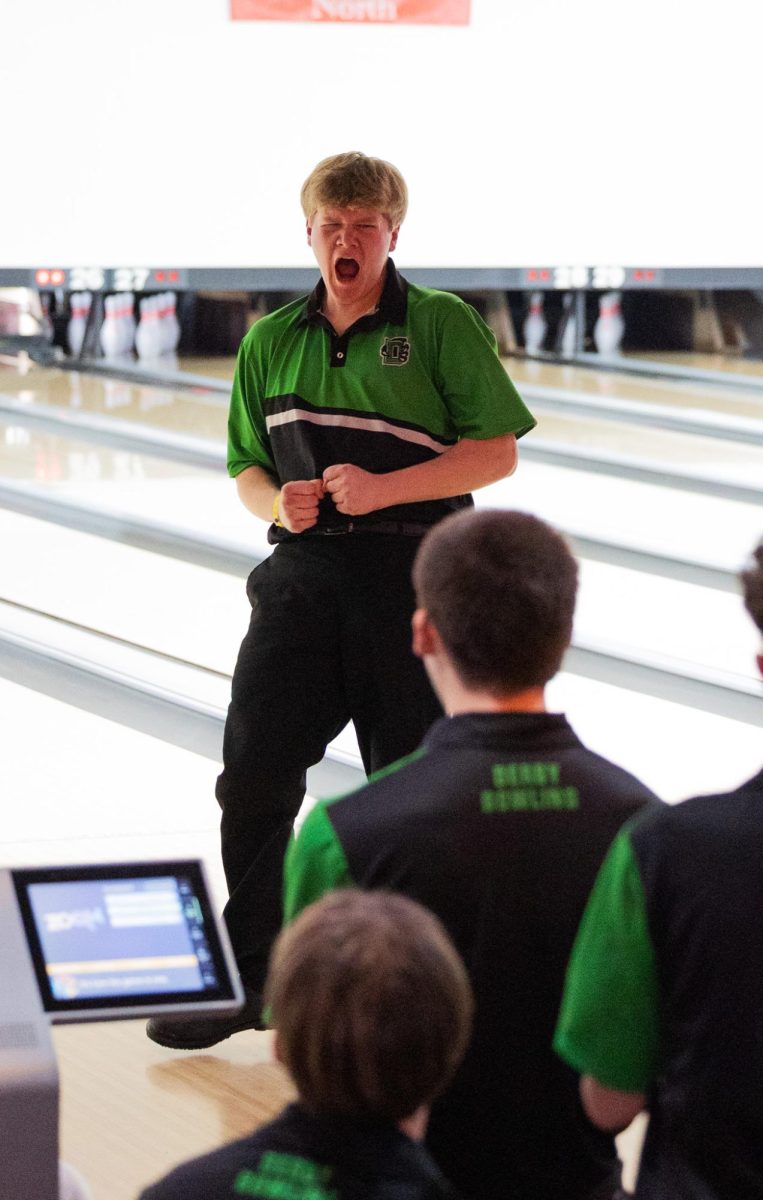 After bowling a strike t the state tournament on March fourth, senior Cash Carns celebrates. 