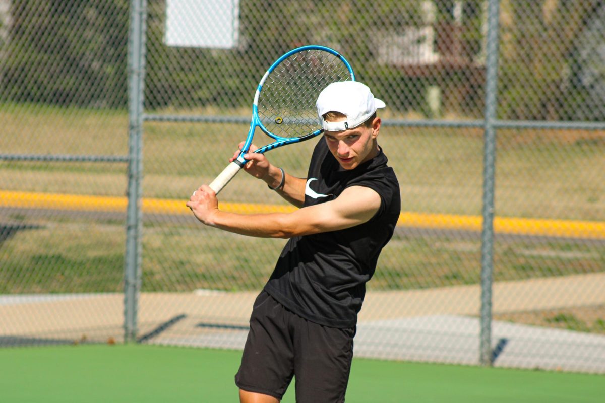 Tennis players practicing outside. 