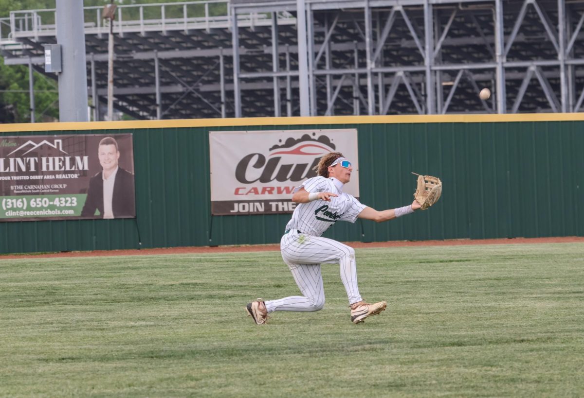 Player runs with glove out to attempt at catching the ball. 