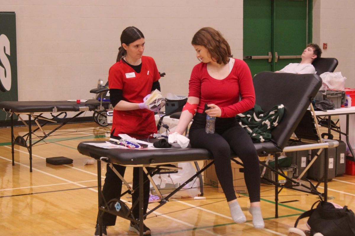 Student looks down to watch blood drive clean up.