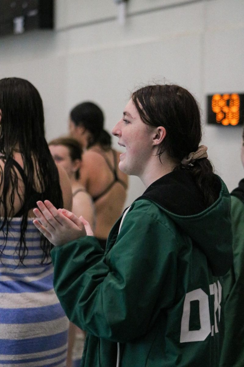 Swimmer cheers for teammate. 