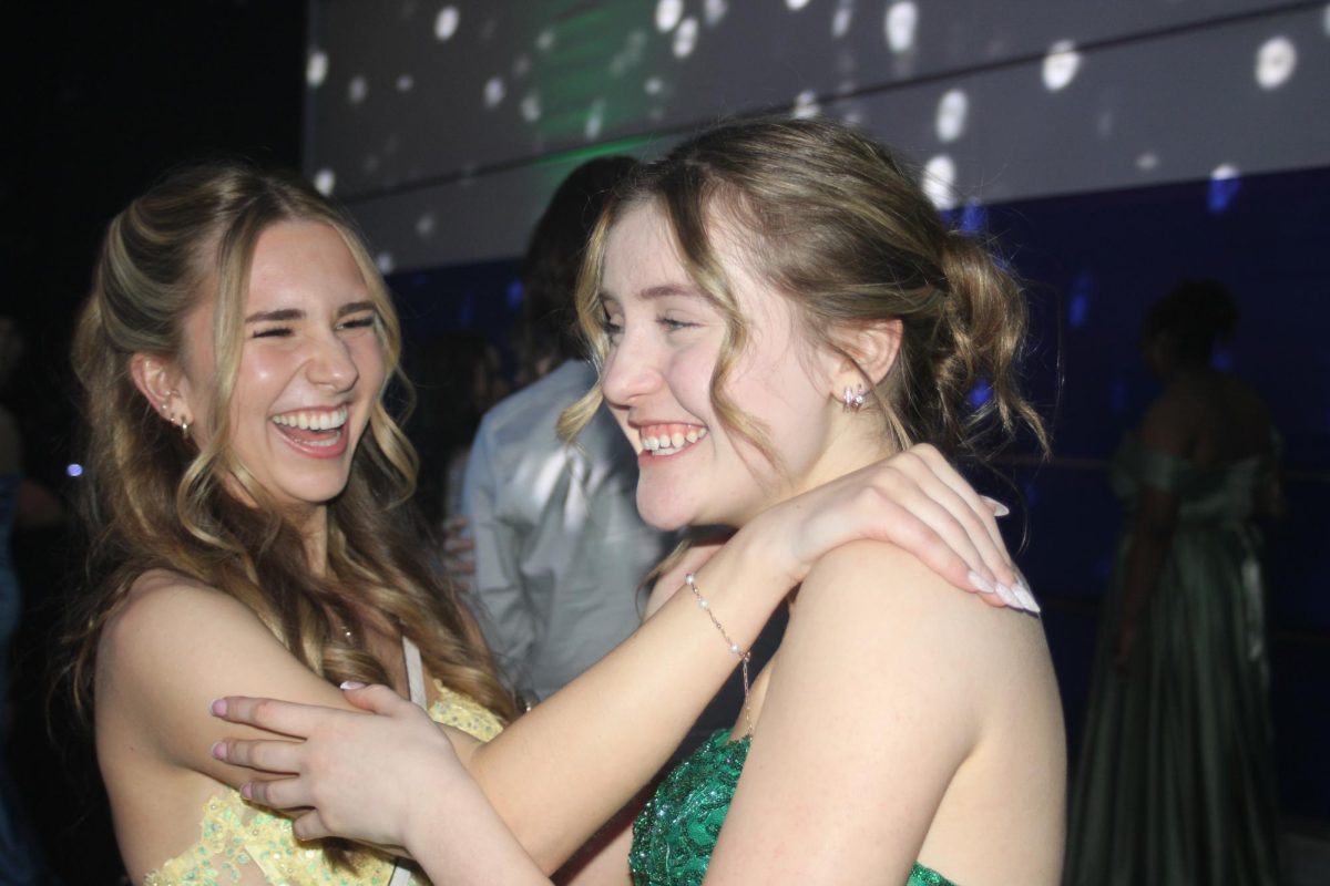 Students laugh together at prom. 