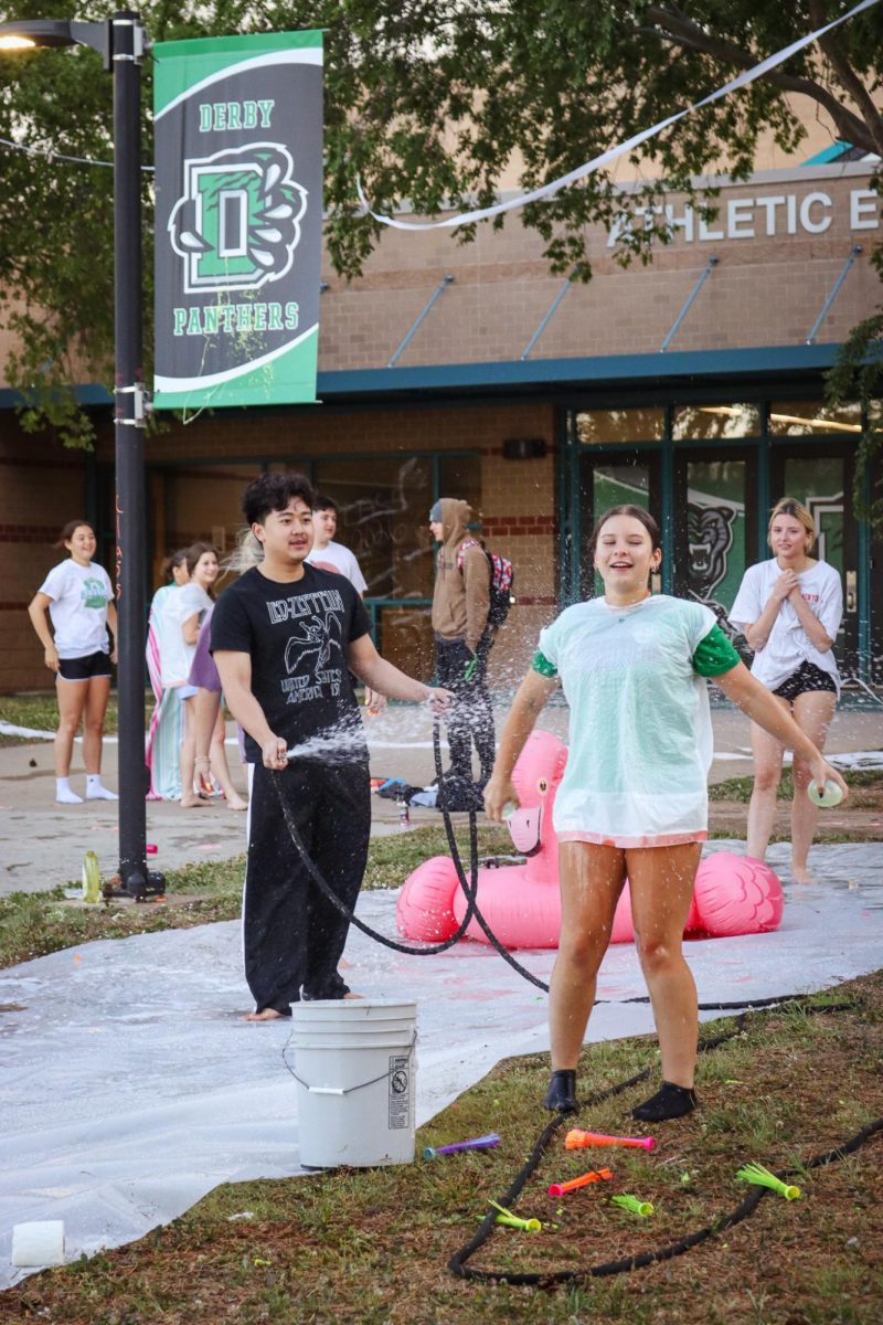 Seniors splashing each-other with water.