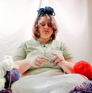 Freshman Addison Casey crochet's among piles of yarn